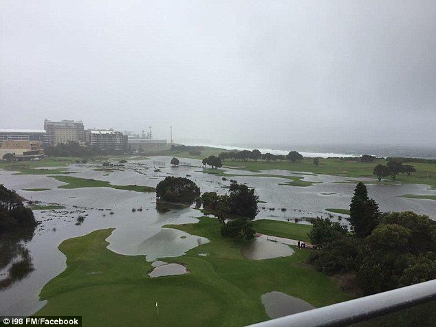 A golf course is seen almost entirely underwater in Albion Park yesterday as flash flooding hit the area during heavy rains