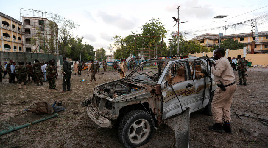 Somali security officers secure the scene of a suicide car explosion in front of the national theatre in Mogadishu