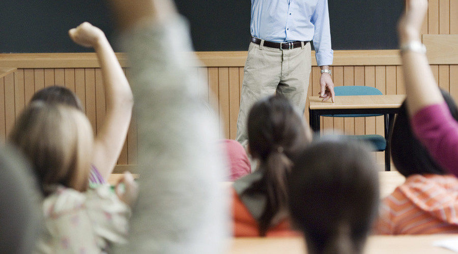 Kids raising hands in classroom