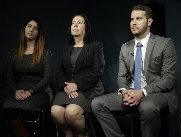 Christine Levinson, center, wife of Robert Levinson, and her children, Dan and Samantha Levinson, talk to reporters