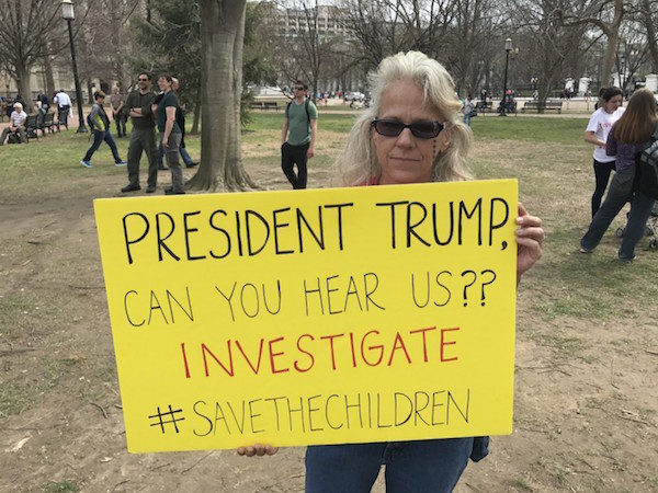 Click to enlarge Dawn Wolf holds up a sign