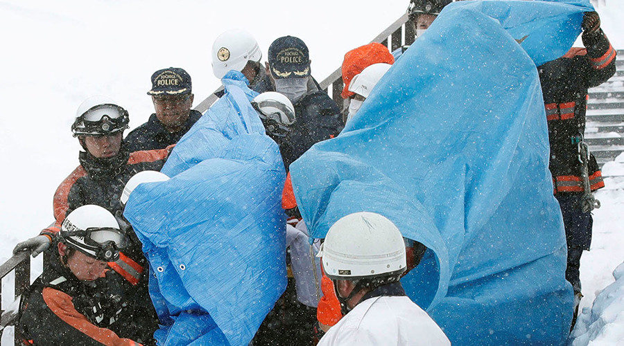 Click to enlarge Rescue workers carry victims near a ski resort in Nasu town, north of Tokyo, Japan, March 27, 2017