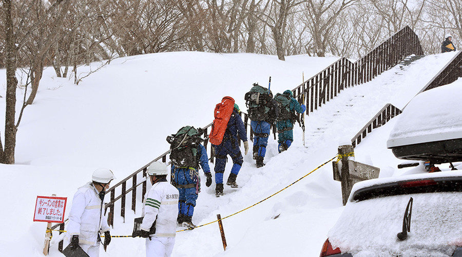 Click to enlarge Rescue workers climb toward a mountain for searching missing people after an avalanche near a ski resort in Nasu town, north of Tokyo, Japan, March 27, 2017