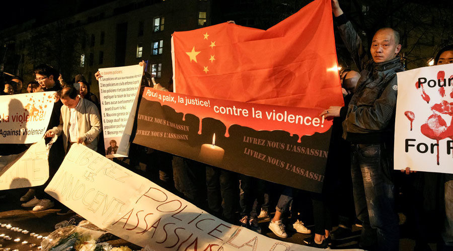 Click to enlarge A man hold a Chinese flag during a protes