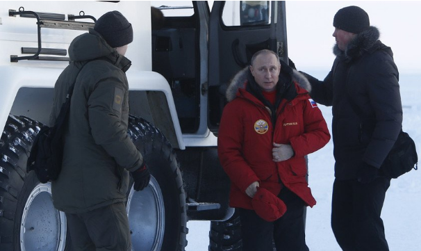 Russian President Vladimir Putin walks out of a car during a visit to Alexandra Land in remote Arctic islands of Franz Josef Land, Russia March 29, 2017
