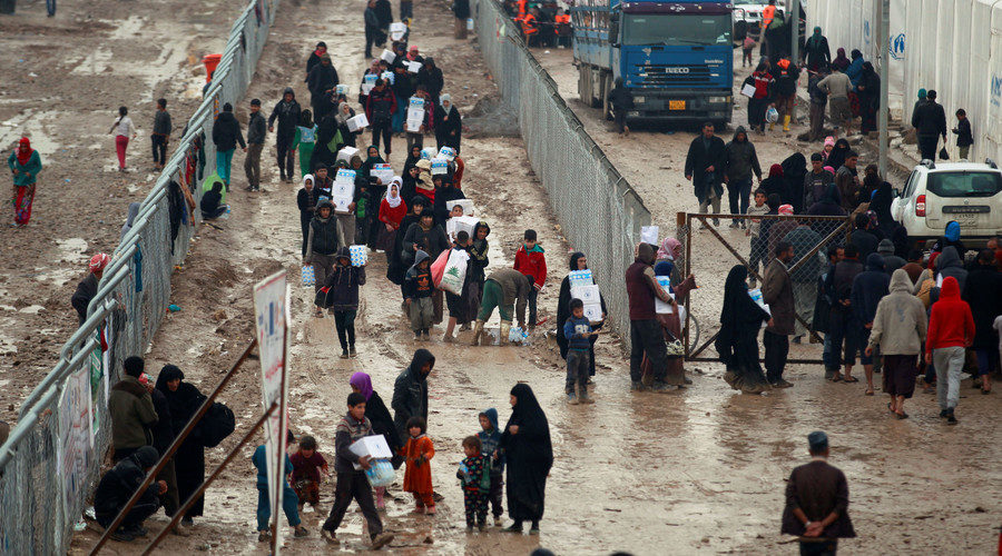 Displaced Iraqi people receive aid as Iraqi forces battle with Islamic State militants in Mosul, at Hammam al-Alil camp, Iraq March 23, 2017