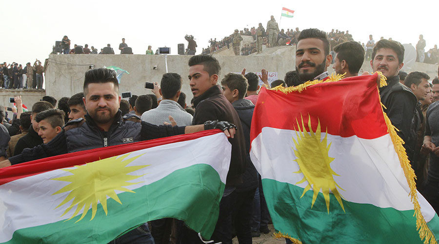 Kurdish residents hold flags during Norouz celebrations in Kirkuk, north of Baghdad