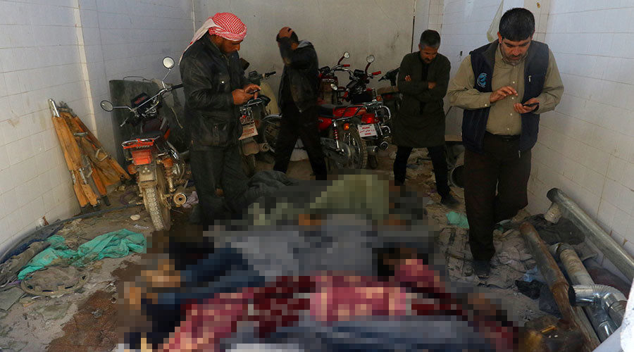 Men stand near dead bodies following a suspected gas attack in the town of Khan Sheikhoun, Idlib, Syria. April 4, 2017