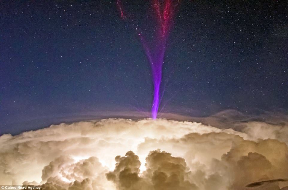 Click to enlarge These stunning photos show THE violet stream shooting out from the top of a cloud.
