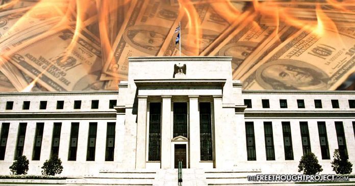 Federal Reserve building with burning cash graphic