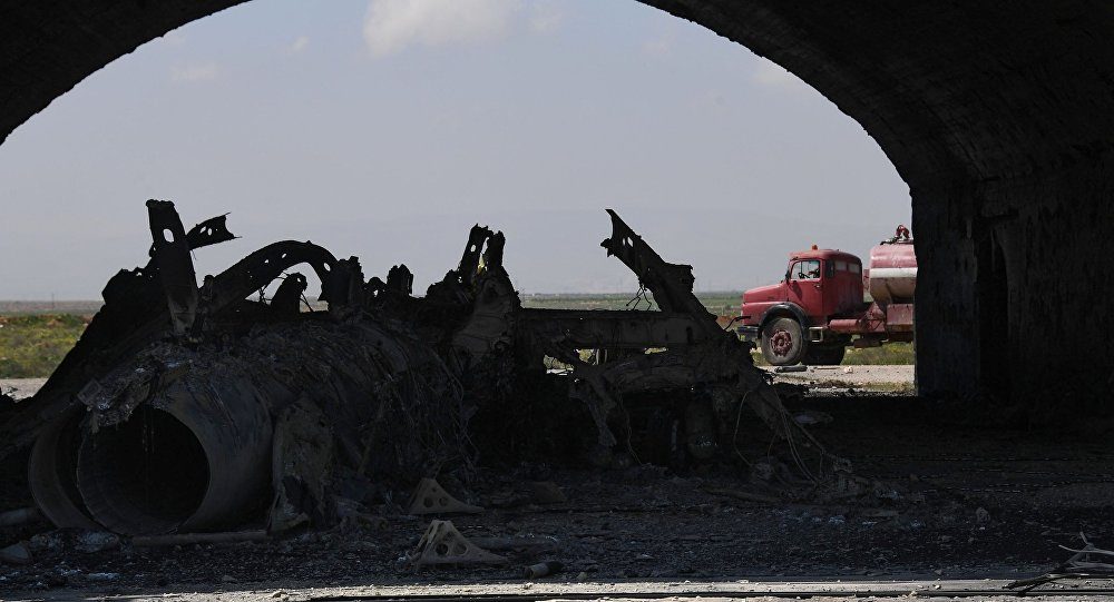 The body of a plane burned as a result of the US missile attack on an air base in Syria