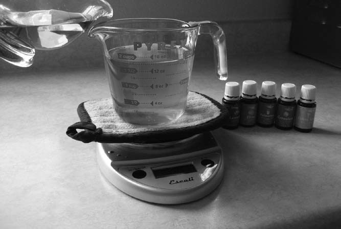 Adding olive oil to melted tallow.