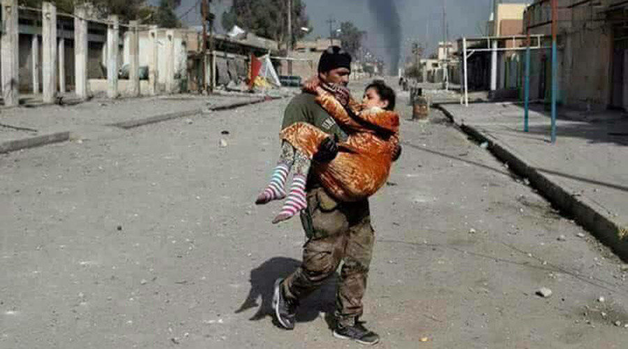 Man carrying child in Mosul