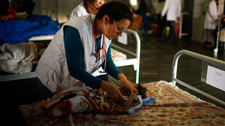 A doctor checks an Iraqi girl at a hospital in Qayyara, Iraq