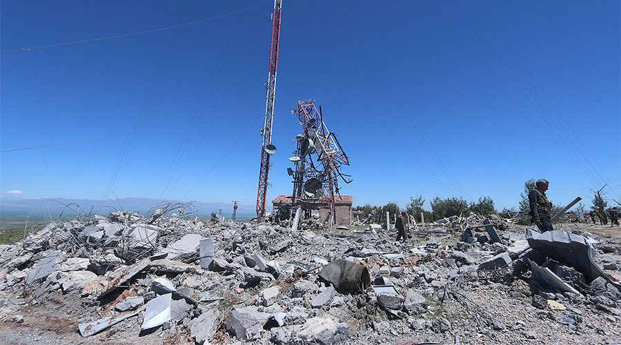 Members of the Kurdish People's Protection Units (YPG) inspect the damage at their headquarters