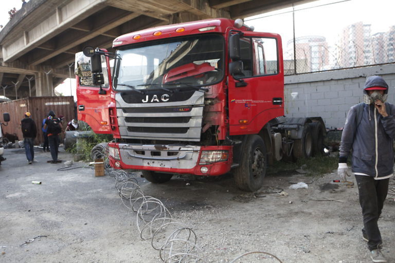 Click to enlarge Protesters damaged government vehicles