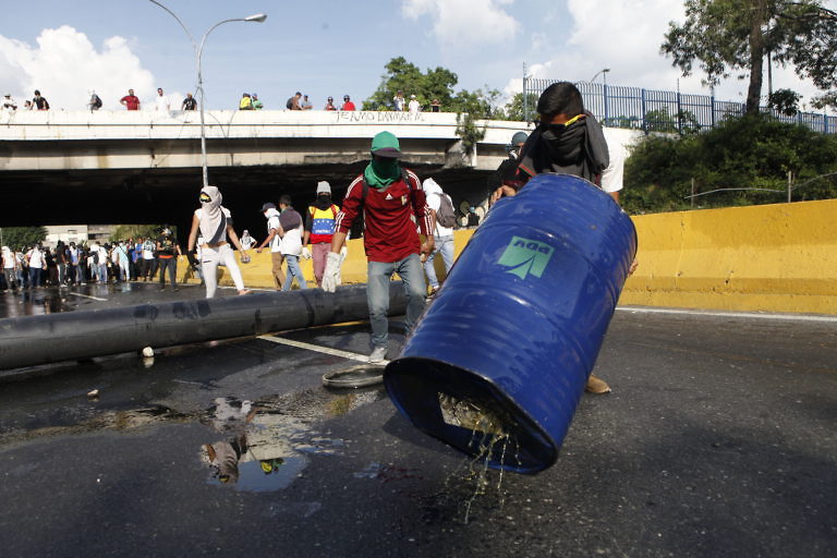 Click to enlarge Demonstrators soak highways in motor oil