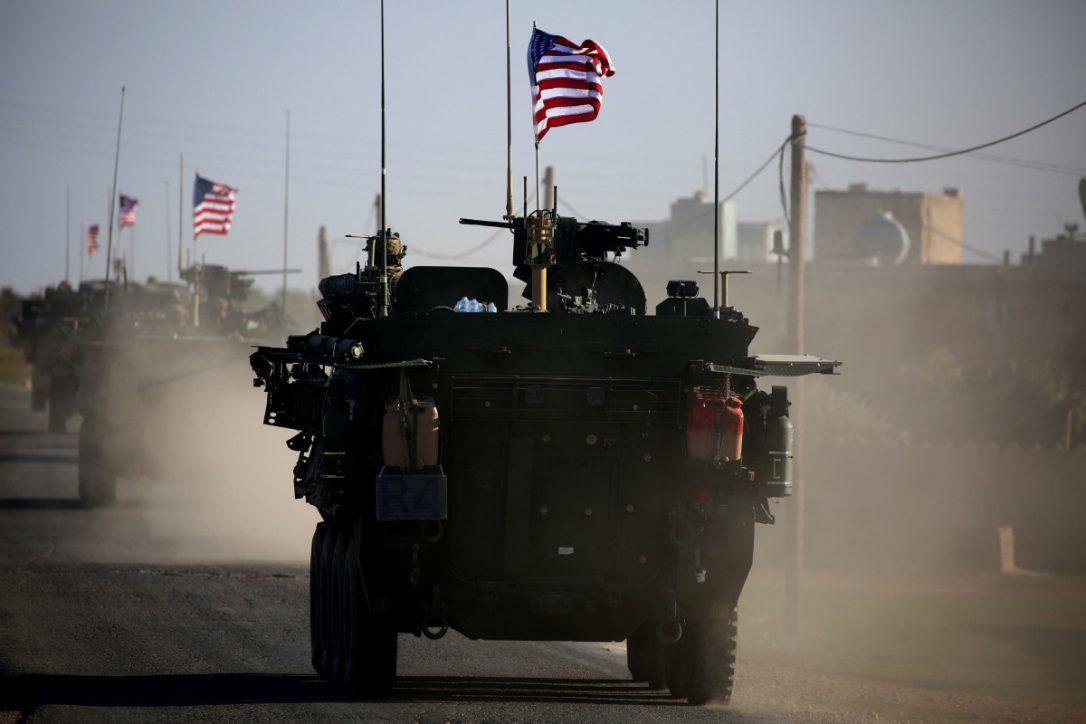 March 5 photo shows a convoy of U.S. forces armoured vehicles driving near the village of Yalanli, on the western outskirts of the northern Syrian city of Manbij