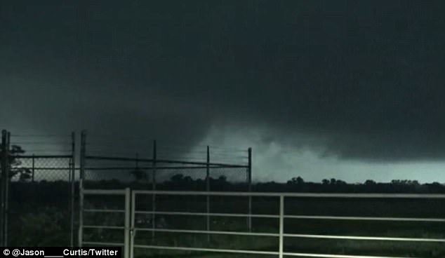 A tornado is pictured casting ominous dark shadow over Canton, Texas, about 50 miles east of Dallas