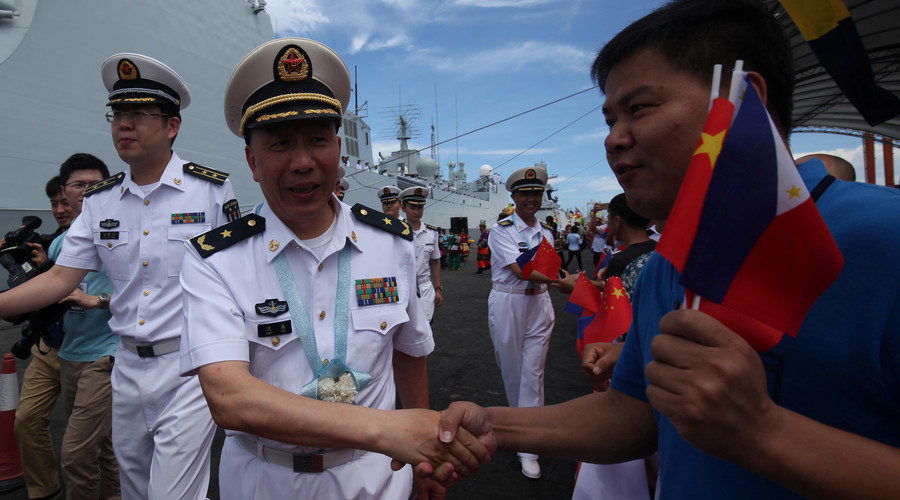 Click to enlarge Filipino-Chinese residents greet China People's Liberation Army Navy