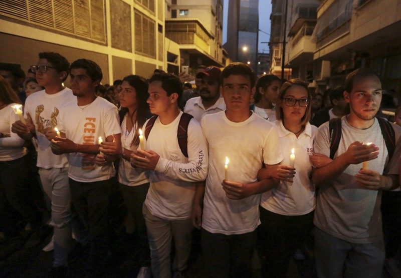 University students hold a candlelight vigil for their late classmate Juan Pablo Pernalete in Caracas, Venezuela