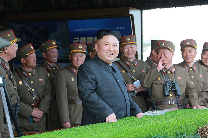 Click to enlarge Kim Jong Un watches a military drill