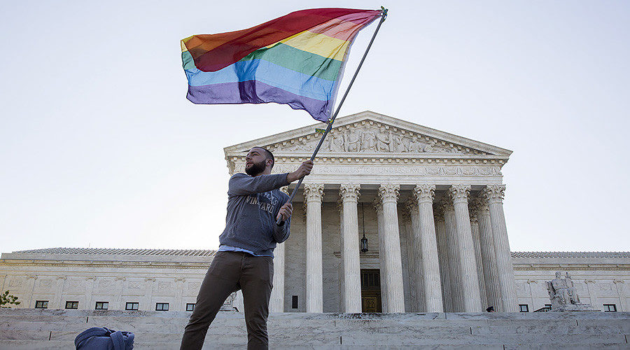 man waves gay rights flag