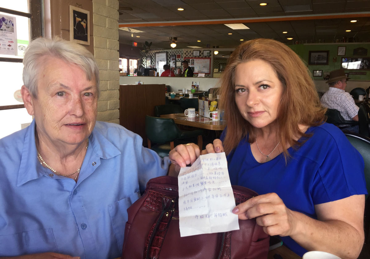 Christel Wallace, left, found a note in the purse she bought at Walmart