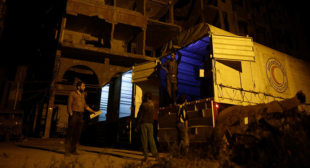 relief workers unload humanitarian aid