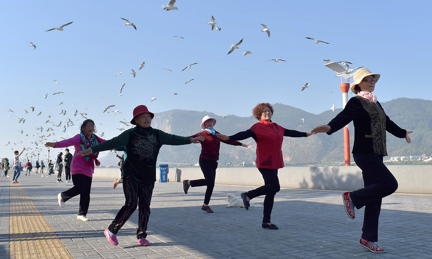 Click to enlarge Chinese pensioners exercise in a park