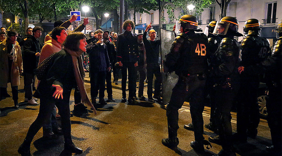 People face riot police in Menilmontant district of Paris
