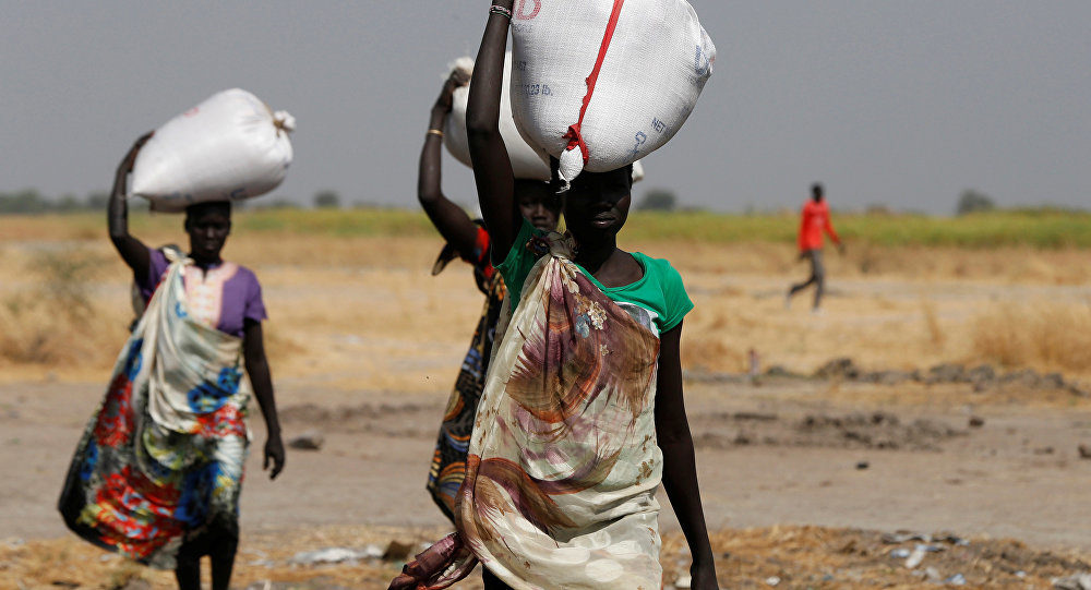 Woman carry sacks of food