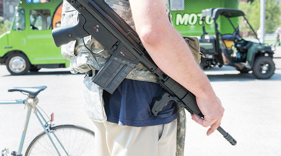 Click to enlarge man carrying automatic weapon