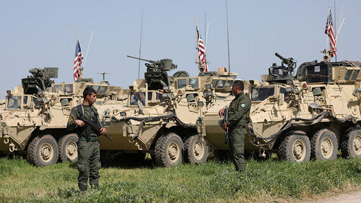 YPG stand near U.S military vehicles