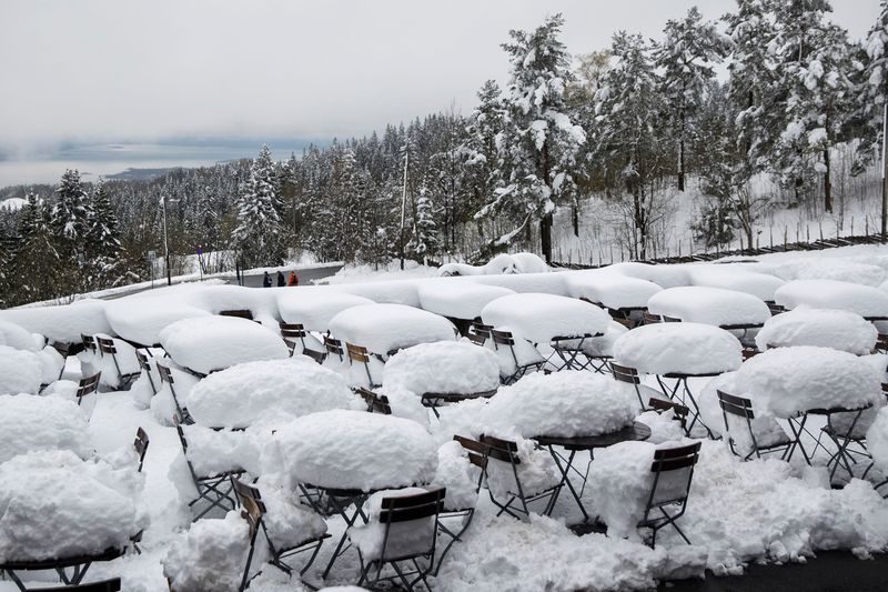 Snow covers an outdoor cafe in Holmenkollen, Oslo, Norway, on May 11, 2017