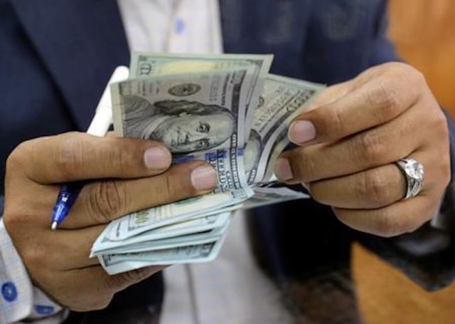 Man counting U.S. bills