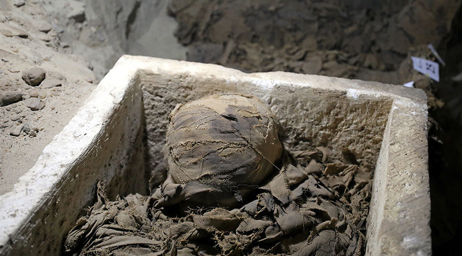 A mummy inside the newly discovered burial site in Minya, Egypt