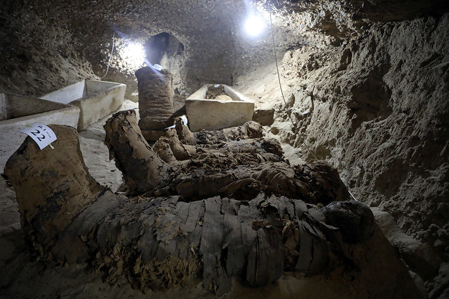 Click to enlarge mummy inside the newly discovered burial site in Minya
