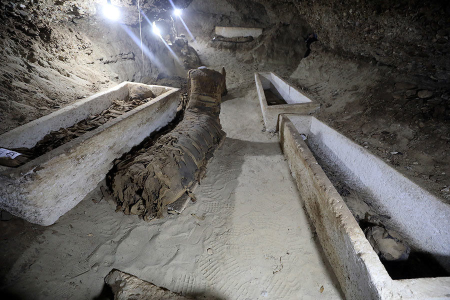 Click to enlarge mummy inside the newly discovered burial site in Minya