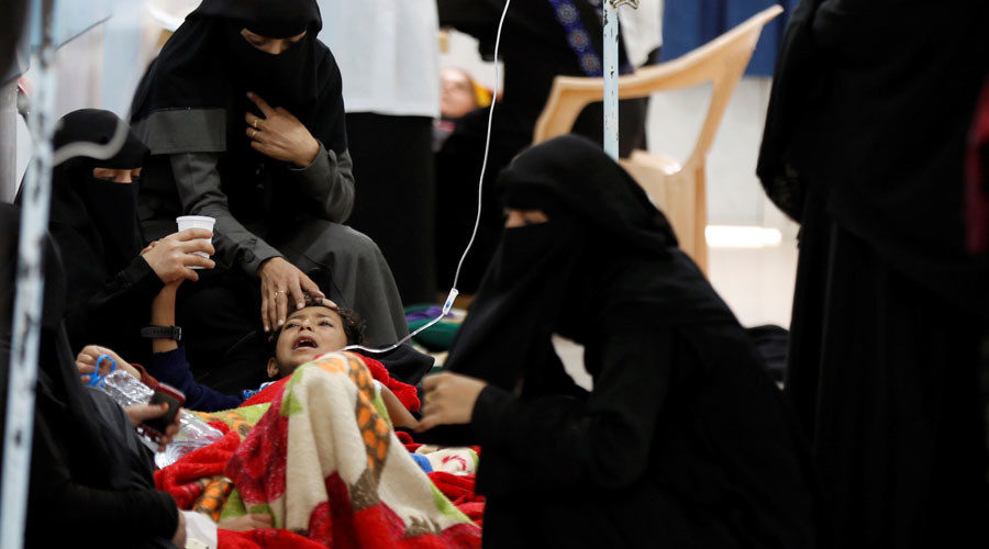 women help relative with cholera yemen