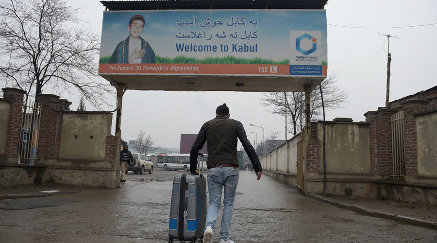 Click to enlarge An Afghan refugee who was deported from Germany arrives with his belongings at the international airport in Kabul