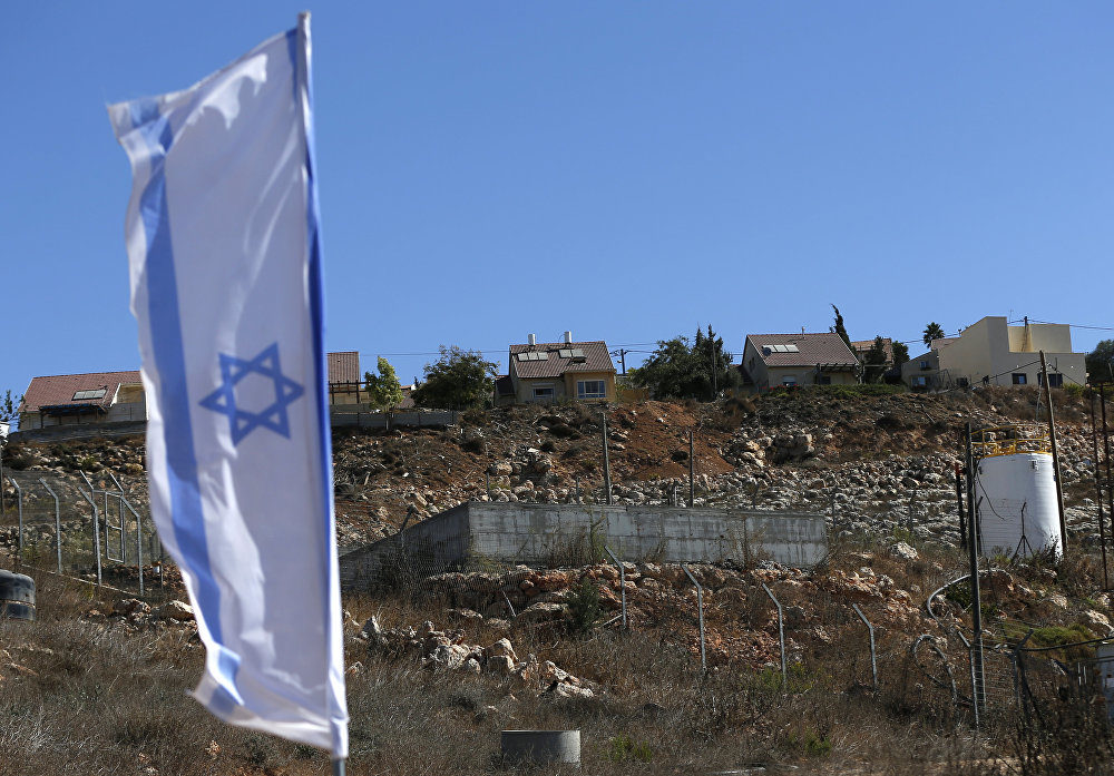 Click to enlarge Israeli national flag flying next to an Israeli building site of new housing units in the Jewish settlement of Shilo