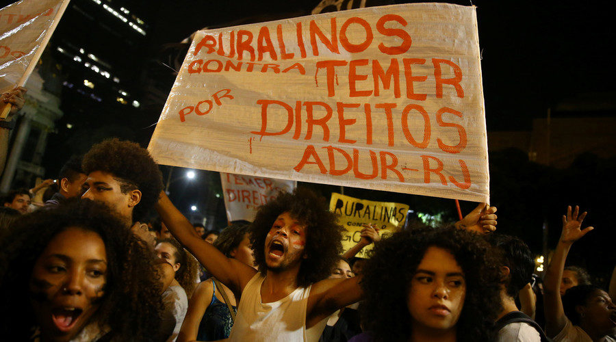 demonstrator holds a sign during a protest against Brazil's President Michel Temer