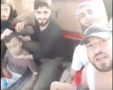 Click to enlarge U.S.-backed Syrian “moderate” rebels smile as they prepare to behead a 12-year-old boy