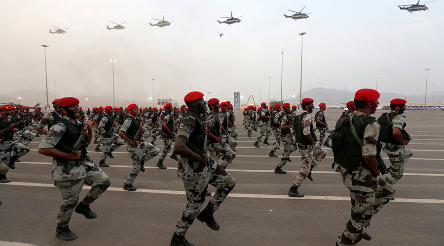 Click to enlarge Members of Saudi security forces take part in a military parade