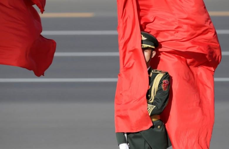 Chinese soldier holds flag, China