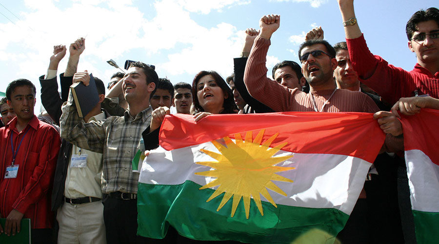 Click to enlarge Young Kurdish Iraqis carry the flag of the Kurdistan Regional Government in Iraq