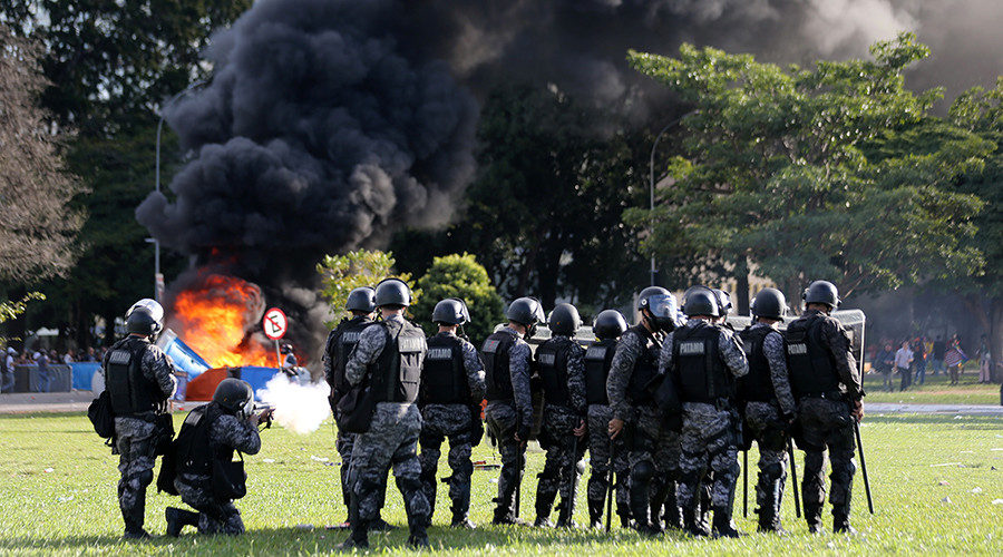 Riot police officers clash with demonstrators in Brasilia, Brazil