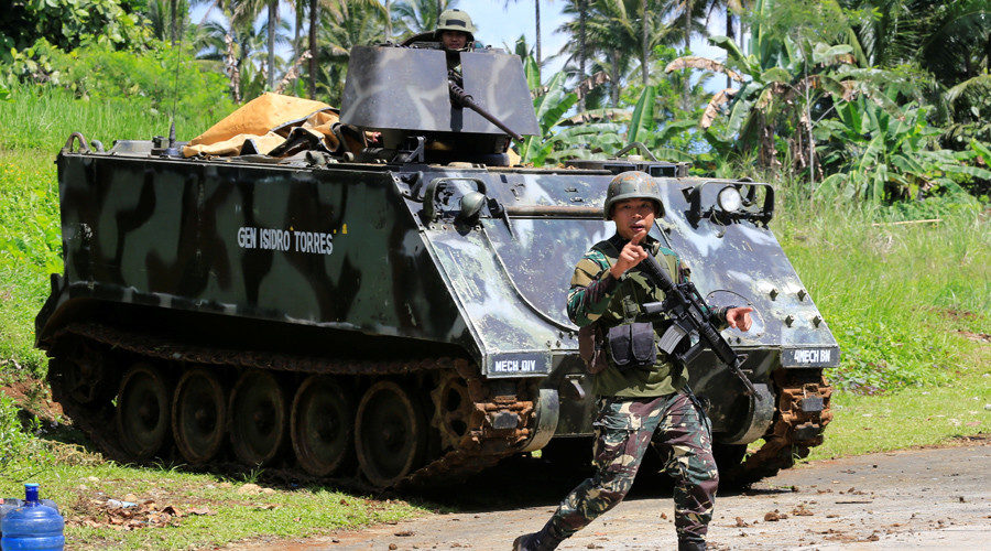 A government troop gestures to people evacuating Marawi city, southern Philippines