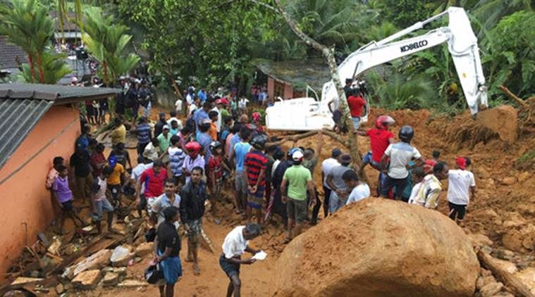 Locals gather to watch rescue operation in Bellana village in Kalutara district, Sri Lanka, Friday. 